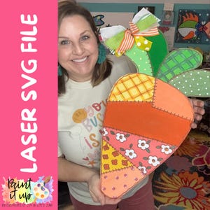May include: A large, colorful carrot-shaped wooden cutout with a patchwork design. The carrot features orange, yellow, and pink sections with floral and geometric patterns. The text "LASER SVG FILE" is on the left, with "Paint it up" and other text at the bottom.