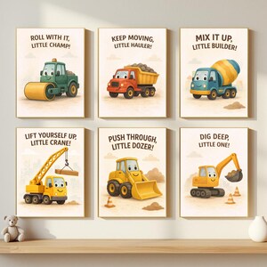 May include: Six framed prints with construction vehicles and motivational phrases. The prints feature a green roller, red dump truck, blue cement mixer, yellow crane, yellow bulldozer, and yellow excavator. Each print has a different phrase like "Roll with it, Little Champ!"