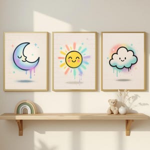 May include: Three framed art prints with cheerful illustrations. The first print shows a smiling crescent moon in purple and blue. The second print depicts a smiling sun with colourful rays. The third print displays a smiling cloud with blue and purple drips.