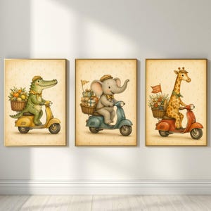 May include: A set of three framed wall art prints featuring a green crocodile on a yellow scooter, a grey elephant on a blue scooter, and a yellow giraffe on a red scooter. Each animal carries a wicker basket filled with items on the back.