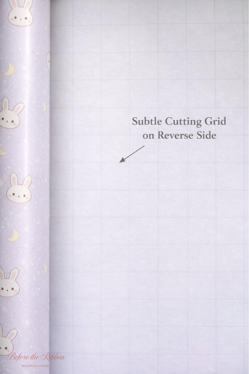 May include: A roll of wrapping paper with a light purple background. The paper is decorated with repeating illustrations of bunny faces and crescent moons. The text "Subtle Cutting Grid on Reverse Side" is visible. The brand name "Before the Ribbon" is also visible.