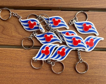 May include: A collection of keychains featuring a white, wave-shaped design with three blue stripes and a red Mickey Mouse head silhouette. Each keychain includes a silver-toned metal split ring attached by a short chain, showcasing a nautical theme.