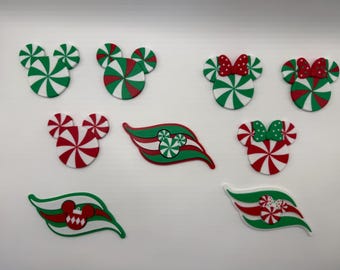 May include: A collection of flat, decorative ornaments featuring peppermint candy patterns in red, white, and green. The set includes mouse-shaped icons, some with bows, and stylized wave-shaped pieces with integrated peppermint and ornament motifs.