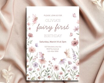 May include: A white invitation card with the text "Olivia's fairy first birthday" in a whimsical font. The card is decorated with watercolor illustrations of fairies, flowers, and butterflies in soft pinks, purples, and greens. The invitation includes the date, time, and RSVP information.