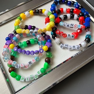 May include: A set of three ceramic mugs with a speckled, matte finish. Each mug features a different color: light blue, cream, and gray. The mugs have a simple, modern design with a rounded shape and a comfortable handle.