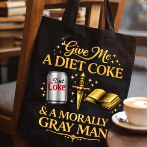 May include: Black tote bag with gold text that reads "Give Me A Diet Coke & A Morally Gray Man." The bag features a Diet Coke can, a sword, and an open book graphic.