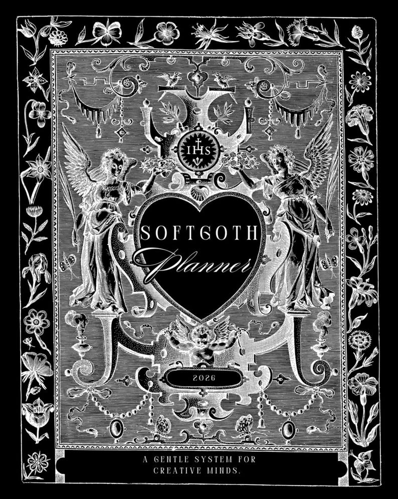 May include: A monochrome Softgoth planner cover with detailed floral and angel imagery. The design includes a heart shape with the text "Softgoth Planner" and the year "2026". The bottom of the cover reads "A gentle system for creative minds."