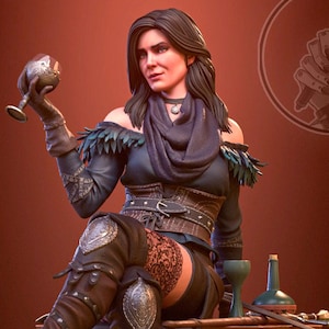 May include: A detailed figurine of a woman in a dark outfit, seated and holding a goblet. She wears a dark blue top with feather accents, a scarf, and knee-high boots. The figure is posed near a small table with a bottle and other items. The background is a gradient of red.