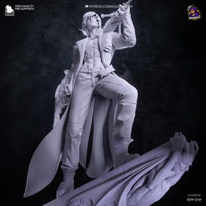 May include: A gray resin figurine of a character with short hair, wearing an open jacket and pants, holding a sword with a skull hilt over one shoulder and a handgun in the other hand. The figure stands atop a base featuring a sculpted creature.