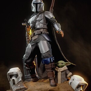 May include: A detailed figurine of The Mandalorian, clad in silver armor, holding a blaster and a rifle. The figure stands with Grogu, and two white helmets are at the base. The KC Studio logo is in the top left corner.