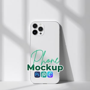 May include: A white smartphone mockup with a triple-lens camera is displayed against a white background. The phone has the words "Phone Mockup" in green script, with the Adobe Photoshop, Adobe Illustrator, and Adobe Creative Cloud logos.