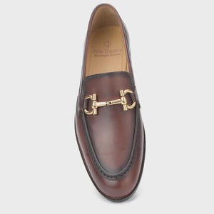 Handmade mahogany brown leather horsebit loafers for men featuring a gold metal horsebit, moc toe stitching, premium leather construction, and classic slip-on design for formal and business casual wear.