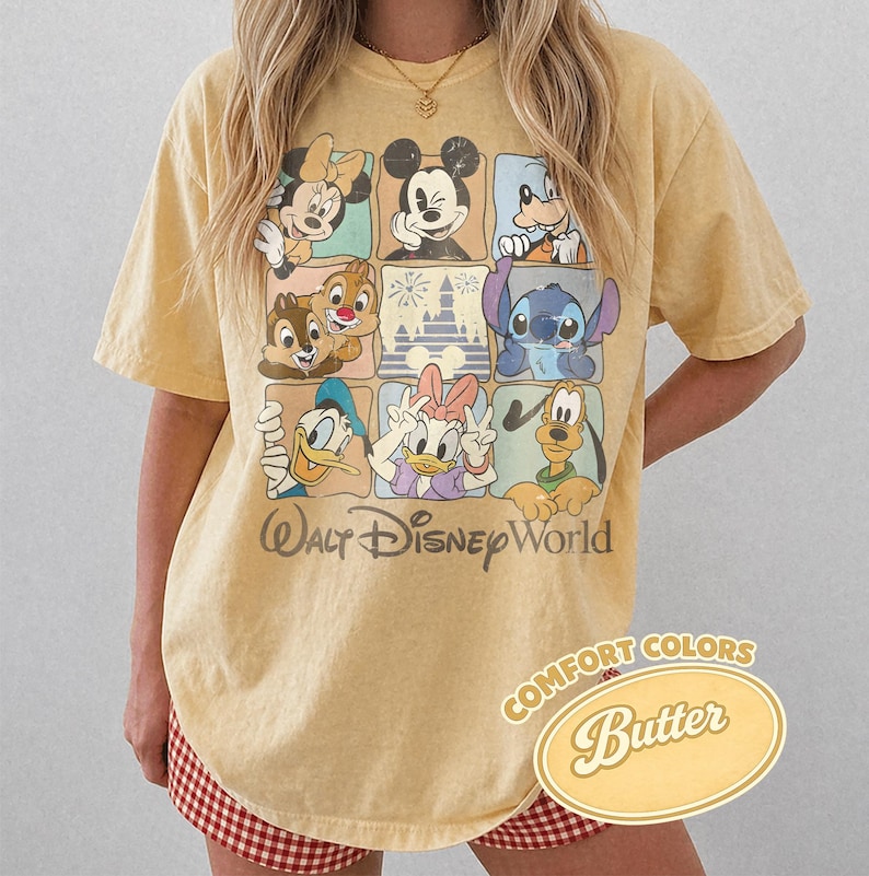 May include: Yellow t-shirt featuring a grid of Disney characters including Mickey Mouse, Minnie Mouse, Donald Duck, and Stitch. The shirt has the text "Walt Disney World" and "Comfort Colors Butter" printed on it.