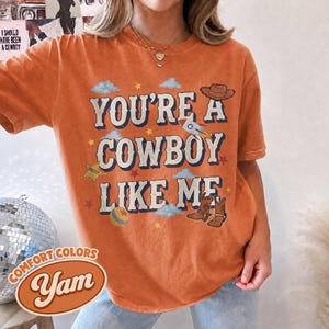 Vintage Tay Story Shirt, You're A Cowboy Like Me Shirt, Toy Story 5 Shirt, WDW Disneyland Family Vacation Trip Tee, Disney Pixar Fest Shirt Yam/Orange