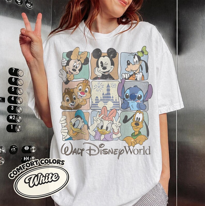 May include: White t-shirt featuring a grid of Disney characters including Mickey Mouse, Minnie Mouse, Goofy, Donald Duck, Daisy Duck, Chip and Dale, Stitch, and Pluto. The words "Walt Disney World" are printed below the grid.