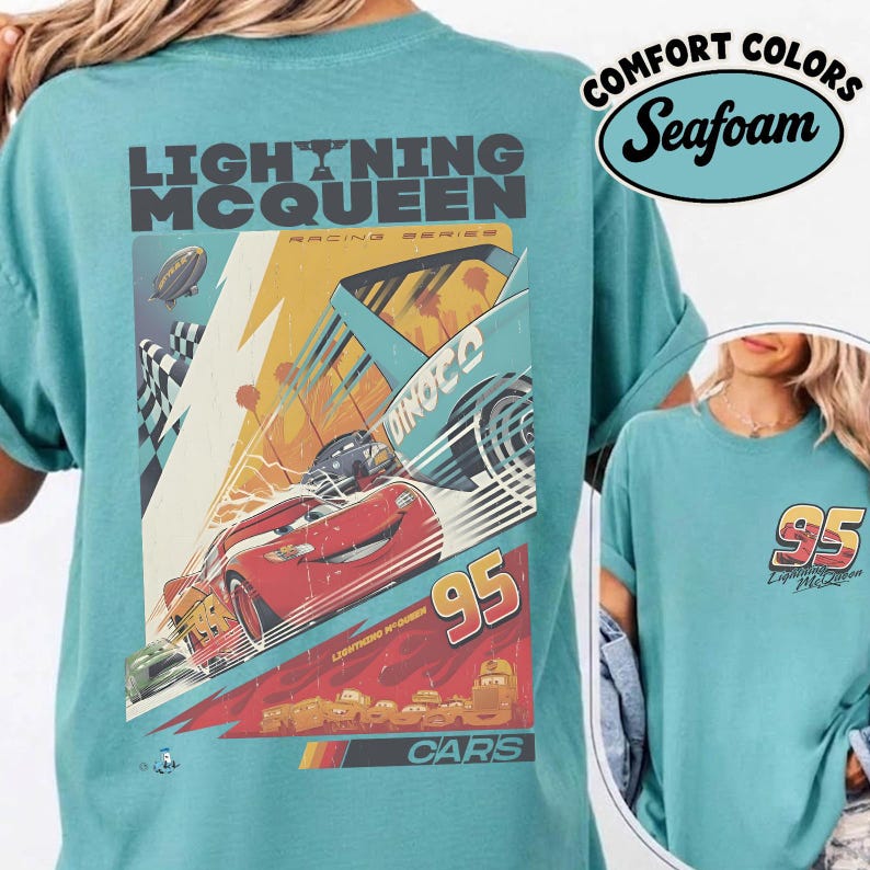 May include: Seafoam green t-shirt featuring a graphic of Lightning McQueen from the Cars movie. The design includes the number 95, the Dinoco logo, and the words "Lightning McQueen" and "Cars". The shirt also has the words "Comfort Colors" and "Seafoam".