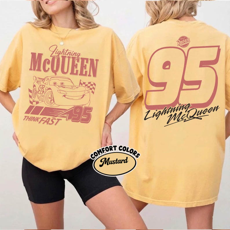 May include: Mustard-colored t-shirt featuring Lightning McQueen from the movie Cars. The front graphic includes the character, the number 95, and the words "Lightning McQueen" and "Think Fast." The back of the shirt displays a large number 95 and the character's name.