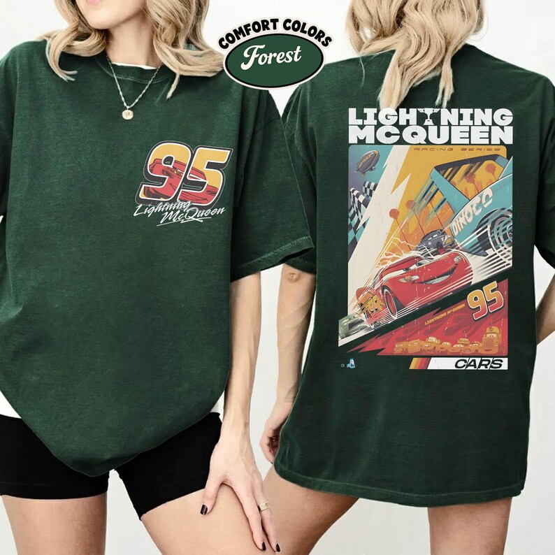 May include: Forest green t-shirt featuring the number 95 and "Lightning McQueen" on the front. The back of the shirt displays a racing scene with the text "Lightning McQueen Racing Series" and the number 95. The shirt is labeled "Comfort Colors".