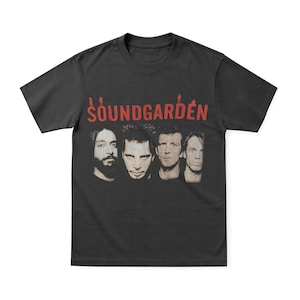 May include: Black t-shirt featuring the band Soundgarden. The band's name is printed in red above a faded image of the band members' faces. The shirt is a classic crew neck style.