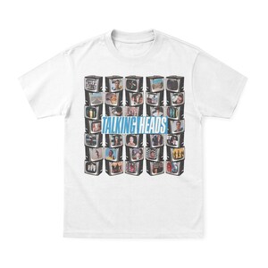 May include: White t-shirt with a graphic of stacked vintage televisions, each showing a different image. The blue text "TALKING HEADS" is across the centre. The shirt is made of a soft, comfortable material.