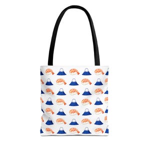 May include: A white tote bag with black handles featuring a repeating pattern of watercolour-style orange shrimp sushi pieces and dark blue triangular mountain shapes. The design is evenly spaced across the entire surface of the fabric bag.