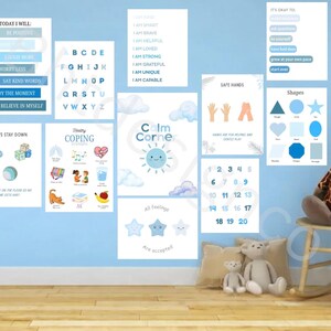 May include: A collection of educational wall art and decor in shades of blue, including posters with the alphabet, shapes, numbers, and positive affirmations. A stuffed giraffe sits on a wooden rocking chair, with stuffed animals on the floor.