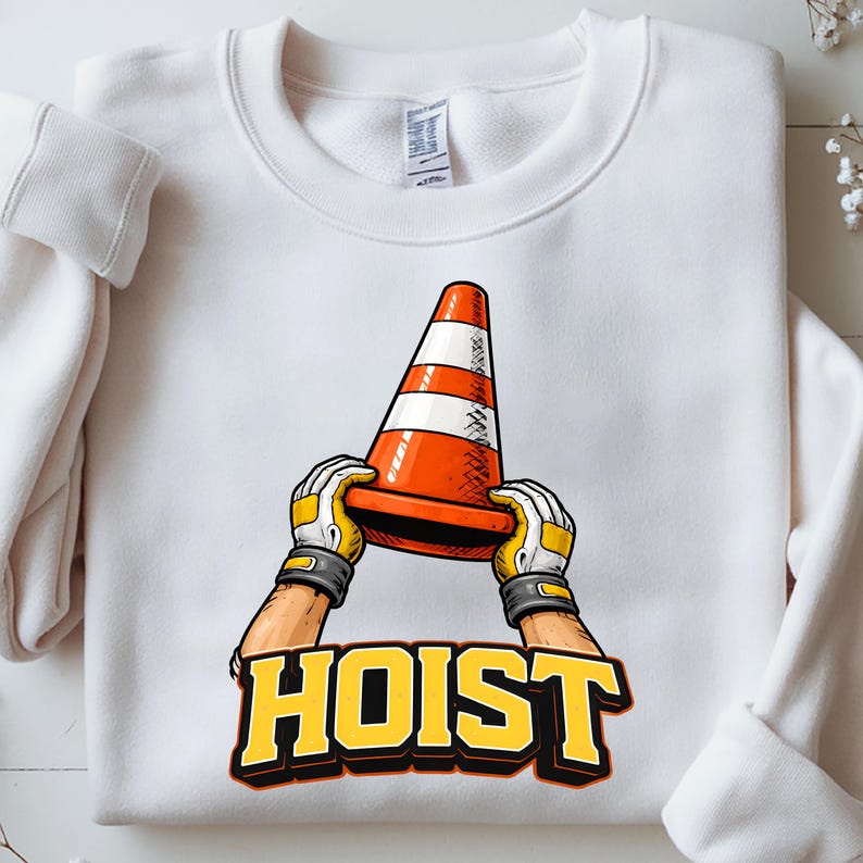 May include: White sweatshirt featuring a graphic of a traffic cone held by gloved hands. The cone is orange with white stripes. The word "HOIST" is printed in yellow block letters with a black outline.