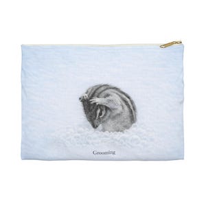 May include: A light blue zippered pouch featuring a detailed black and white illustration of a chipmunk grooming itself. The word "Grooming" is printed below the chipmunk. The pouch has a gold-colored zipper.
