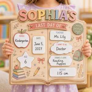 May include: A wooden sign shaped like an open book with the text SOPHIA'S LAST DAY OF. It features sections for Grade Kindergarten, Date June 5, 2027, Age 6, Teacher Ms. Lily, I Want To Be Doctor, Things I Love Reading, Puppies, and Height 115 cm.