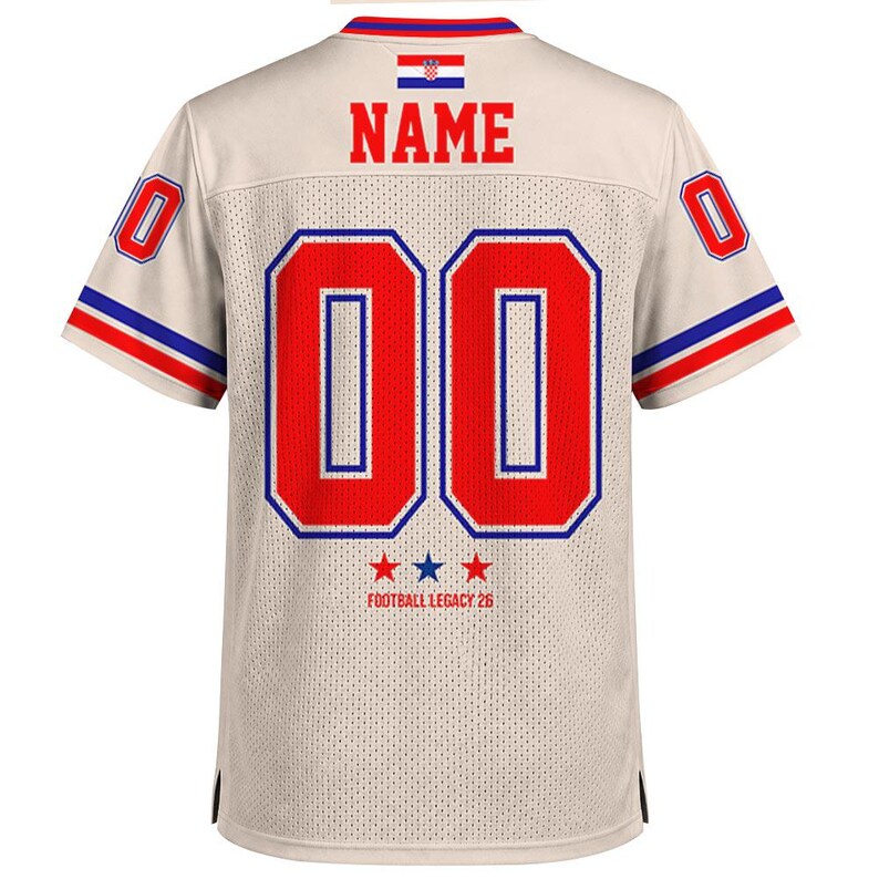May include: A beige mesh jersey featuring the word NAME in red letters above the number 00 in red with blue outlines. The Croatian flag is centered at the top. The sleeves have red and blue stripes, and the text FOOTBALL LEGACY 26 appears below the number with three stars.