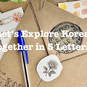 May include: A brown kraft paper envelope with a blue ballpoint pen, a rose sticker, and a circular hand-drawn design. The envelope features the text "Let's Explore Korea Together in 5 Letters!" and "ALL THE WAY FROM KOREA" alongside decorative floral stickers.