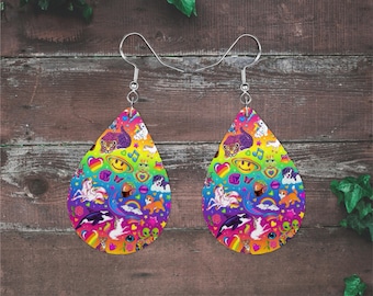 May include: A pair of teardrop-shaped earrings featuring a vibrant, multi-colored rainbow background patterned with various small illustrations including unicorns, cats, dogs, hearts, smiley faces, rainbows, and musical notes, attached to silver-toned hooks.