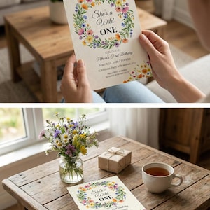 May include: A cream-coloured invitation with the text "She's a Wild One" surrounded by a floral wreath. The invitation details a first birthday party. A wooden table displays a small gift box, a cup of tea, and a vase of flowers.