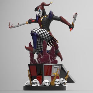 May include: A detailed figurine of a jester in a dynamic pose, holding two swords. The jester wears a black, red, and white checkered outfit, with a mask and a tall hat. The base features skulls, swords, and a box with red and white panels.