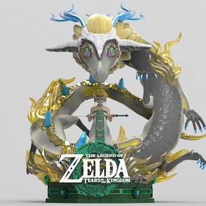 May include: A detailed figurine featuring a dragon encircling a character holding a staff. The dragon is gray with gold accents and blue crystals. The base displays "The Legend of Zelda: Tears of the Kingdom" text.
