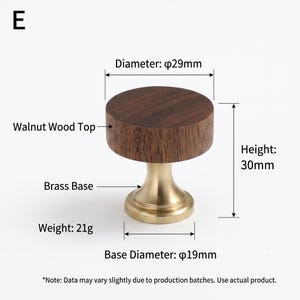 May include: A round cabinet knob with a dark brown walnut wood top and a gold-toned brass base. The knob has a diameter of 29mm, a height of 30mm, a base diameter of 19mm, and a weight of 21g. The image includes the text E, Walnut Wood Top, Brass Base, Diameter: 29mm, Height: 30mm, Base Diameter: 19mm, Weight: 21g.