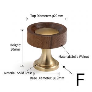 May include: A cabinet knob featuring a circular solid walnut wood top and a solid brass base. The knob has a top diameter of 29mm, a base diameter of 19mm, and a height of 30mm. The design includes a central brass inlay within the wood top.