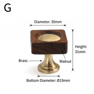 May include: A square cabinet knob featuring a dark brown walnut wood top with a circular brass centre inlay, mounted on a brass base. The knob has a diameter of 30mm, a height of 31mm, and a bottom diameter of 19mm, labelled with G.