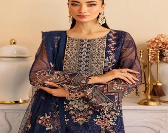 May include: A navy blue embroidered dress with sheer sleeves. The dress features intricate floral and geometric patterns in red, gold, and white. The neckline and cuffs are embellished with detailed embroidery, creating a formal and elegant look.