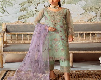 May include: A mint green long-sleeved tunic and matching trousers set featuring intricate floral embroidery and beadwork. The outfit includes a sheer, lavender-colored dupatta with matching floral embroidery and scalloped edges.