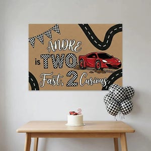 May include: A birthday party scene with a brown backdrop featuring a red race car and the text "Andre is TWO Fast, 2 Curious." A cake with a car topper and checkered balloons are on a wooden table.