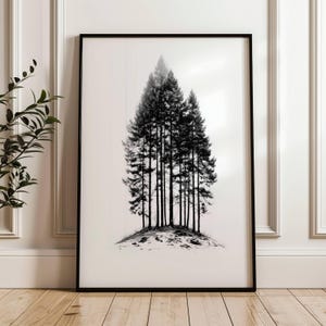 Puede incluir: Lámina enmarcada en blanco y negro que muestra un grupo de pinos. Los árboles están muy juntos, creando una silueta oscura sobre un fondo claro y difuminado. La obra de arte está enmarcada en un marco negro sencillo.