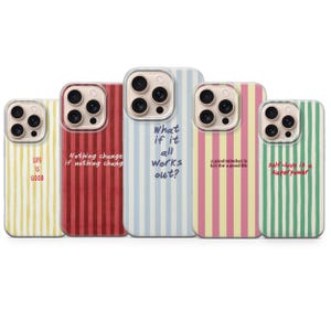 May include: Five smartphone cases with vertical stripes in yellow, red, light blue, pink, and green. Each case features a unique inspirational quote in dark text, including Life is Good, Nothing changes if nothing changes, What if it all works out?, a good mindset is key for a good life, and self-love is a superpower.