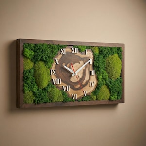 May include: A rectangular wall clock featuring a central live-edge wood slice with visible grain, surrounded by preserved green moss. The clock face displays white Roman numerals and white hour and minute hands with a thin red second hand.