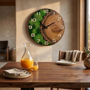 May include: A round wall clock featuring a natural wood slice on the right side and vibrant green preserved moss on the left. The clock face displays raised, light-coloured numerals from 1 to 12 and two thin black hands for indicating the time.