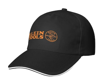 May include: Black baseball cap with the orange "KLEIN TOOLS" logo on the front. The cap has a curved brim with a white stripe along the edge. The cap also has the "KLEIN TOOLS EST. 1857" logo on the side.