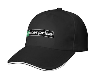 May include: A black baseball cap featuring a white and green rectangular logo with the word enterprise printed in white lowercase letters. The cap has a structured crown, a curved brim, and a thin white piping detail along the edge of the brim.
