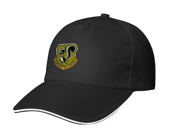 May include: Black baseball cap with a white trim on the brim. The cap features a patch with a skunk illustration and the text "ADP Lockheed" and "Skunk Works" in a yellow and green shield.