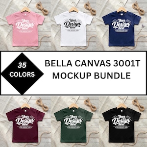 May include: A Bella Canvas 3001T mockup bundle featuring six short-sleeve t-shirts in pink, white, navy, maroon, dark green, and black. Each shirt displays the text Your Design here and Pro Mockup Hub. The text 35 Colors is also visible.