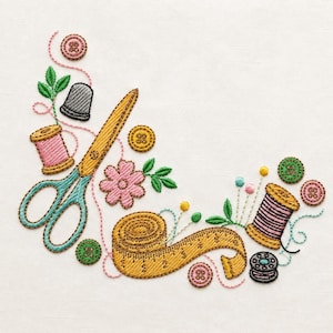 May include: An embroidery design featuring a pair of teal and gold scissors, a yellow measuring tape, two spools of pink thread, a grey thimble, several colourful buttons, a pink flower, and green leaves arranged on a plain white fabric background.